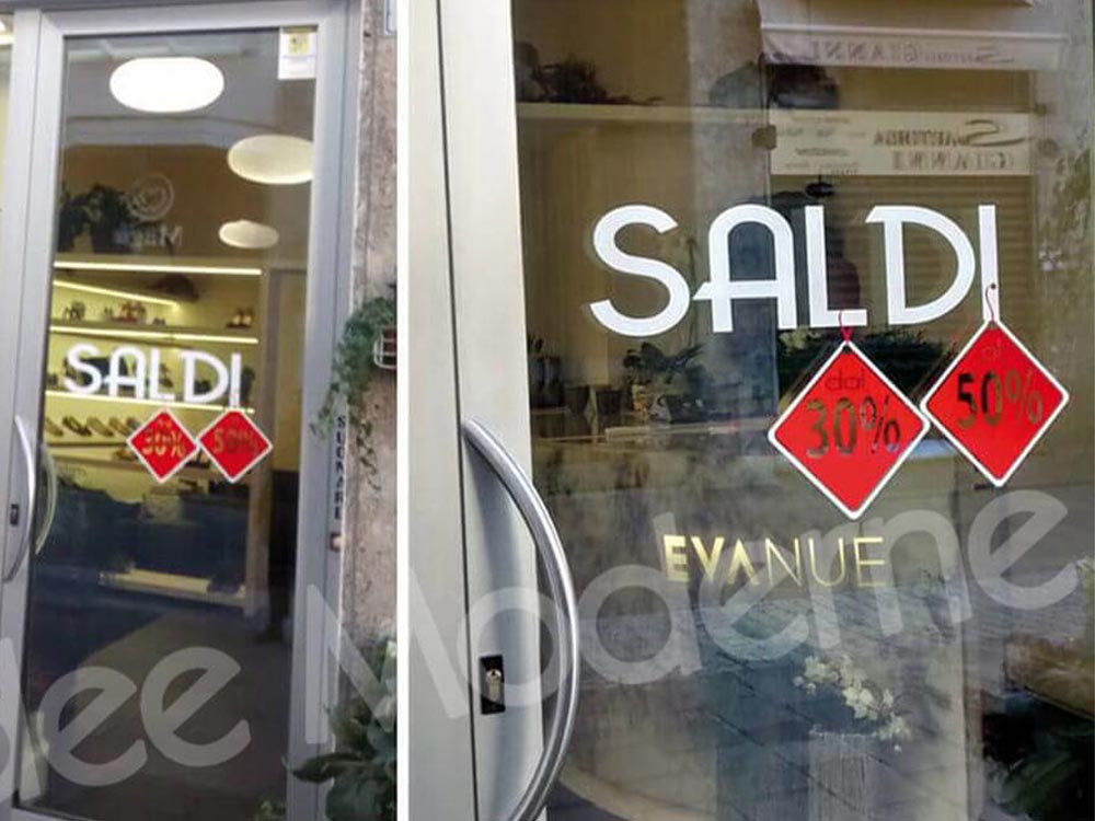 Scritte saldi adesive su vetrina negozio Varese Milano
